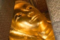 Reclining Buddha gold statue face. Wat Pho, Bangkok, Thailand Royalty Free Stock Photo
