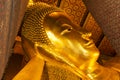 Reclining Buddha gold statue face. Wat Pho, Bangkok, Thailand Royalty Free Stock Photo