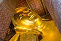 Reclining Buddha gold statue face. Wat Pho, Bangkok, Thailand Royalty Free Stock Photo