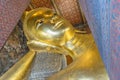 Reclining Buddha gold statue face at Wat Pho, Bangkok, Thailand Royalty Free Stock Photo