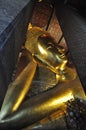 Reclining Buddha gold statue face. Wat Pho, Bangkok, Thailand Royalty Free Stock Photo