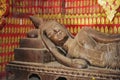 Reclining Buddha statue in a red chapel in Wat Xieng Thong temple in Luang Prabang, Laos. Royalty Free Stock Photo