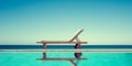 Reclining chair near a swimming pool, sea and blue sky Royalty Free Stock Photo