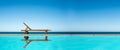 Reclining chair near a swimming pool, sea blue sky panoramic background