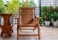 The reclining wooden chair on the terrace with the small garden Royalty Free Stock Photo