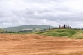 Recognizable Tuscany landscape consisting of a long line of thin cypresses along the driveway to the farm