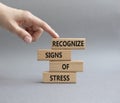 Recognize Signs of Stress symbol. Concept words Recognize Signs of Stress on wooden blocks. Beautiful grey background. Businessman