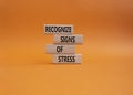 Recognize Signs of Stress symbol. Concept words Recognize Signs of Stress on wooden blocks. Beautiful orange background. Medicine