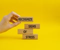 Recognize Signs of Stress symbol. Concept words Recognize Signs of Stress on wooden blocks. Beautiful yellow background.