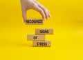 Recognize Signs of Stress symbol. Concept words Recognize Signs of Stress on wooden blocks. Beautiful yellow background.