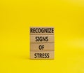 Recognize Signs of Stress symbol. Concept words Recognize Signs of Stress on wooden blocks. Beautiful yellowbackground. Medicine