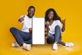 We recommend. Happy black couple demonstrating smartphone with white blank screen and showing thumb up, mockup