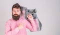 Recommendation concept. Guy shopping on sales season, pointing at bags. Man with beard and mustache carries bunch of Royalty Free Stock Photo