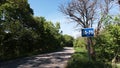 Recommended speed road sign on asphalt road to mountains of Stiavnicke vrchy, central Slovakia, during spring season.