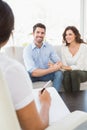 Reconciled couple smiling on couch