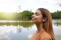 Reconnect with nature. Side view of young woman with closed eyes enjoying breathing in tropical park of Brazil Royalty Free Stock Photo