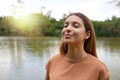 Reconnect with nature. Young woman with closed eyes enjoying breathing in tropical park of Brazil Royalty Free Stock Photo