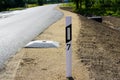 Reconstructed road edge with plastic road post with reflector