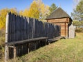 Reconstructed wooden watchtower of the 17th century and a palisade made of sharpened logs in the Siberian village of Umreva in