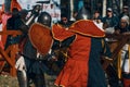 Reconstruction of a medieval battle in the arena with the audience. Royalty Free Stock Photo