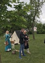 Reconstruction of medieval games: soldiers in armor and cold steel. The ladies are shooting from the bow.