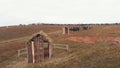 A reconstruction of military operations - small wooden buildings looking like dugouts - people watching on the