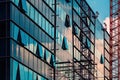 Reconstruction of modern office building with glass facade, construction site with scaffolding and crane forming abstract Royalty Free Stock Photo