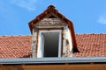 Reconstruction of old dilapidated roof window with already installed new window with white plastic frame on top of family house Royalty Free Stock Photo