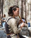 The reconstruction participant of the `Viking Village` plays the flute in the camp in the forest near Ben Shemen in Israel