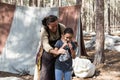 The reconstruction participant of the `Viking Village` teaches the visitor to play the pipe in the camp in the forest near Ben She