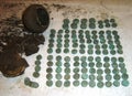 Reconstruction of a placer of silver coins of the 17th century and a jug in the form of a treasure on a white background