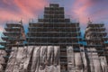 Restoration of the monument. Metal scaffolding around a large and tall building at a construction site.