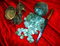 Reconstruction of a treasure from a placer of silver coins of the 17th century, a jug and a knife on a red background