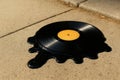 The record melted on the hot asphalt under the sun. Royalty Free Stock Photo