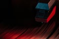 Record player needle reading vinyl record in red light Royalty Free Stock Photo