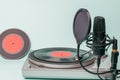 A record player with red vinyl discs and a modern microphone Royalty Free Stock Photo