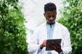 Recording and analyzing data is part of the job. a handsome young botanist using a digital tablet while working outdoors Royalty Free Stock Photo