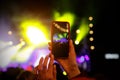 Recording a concert with mobile phone, silhouette of hands with smartphone Royalty Free Stock Photo