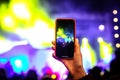 Recording a concert with mobile phone, silhouette of hands with smartphone Royalty Free Stock Photo