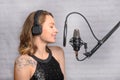 Recording a speech on a radio station, announcer, or singer, blogger works in the studio with a studio microphone. Concept of Royalty Free Stock Photo