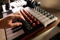 Recording studio, music studio. Musician`s hand on the keys of a midi keyboard. Professional musical equipment. Sound work,