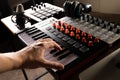 Recording studio, work with sound. Man`s hand on the keys of a midi keyboard, studio microphone, studio headphones on a midi Royalty Free Stock Photo