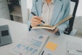 Recording various information on paper, Employees sit and take notes in the office, A businesswoman searches for information on a