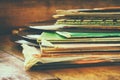 Records stack with record on top over wooden table. vintage filtered Royalty Free Stock Photo