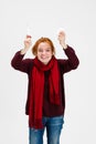 Cropped vertical portrait of young Caucasian girl recovering from a cold isolated over white background. Normal body