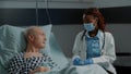 Recovering patient in hospital ward getting consultation Royalty Free Stock Photo