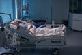 Recovering woman lies on postoperative bed in intensive care unit Royalty Free Stock Photo