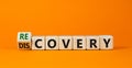 Recovery or discovery symbol. Turned a wooden cube, changed a word `discovery` to `recovery`. Beautiful orange background.