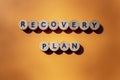 Recovery plan inscription made of wooden letters isolated on orange background. Business concept. Top view. Banner Royalty Free Stock Photo