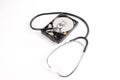 RECOVERY AND REPAIR TECHNOLOGY CONCEPT: Hard Disk Drive HDD with stethoscope isolated on white.